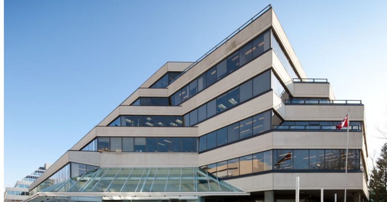Modern multi-story office building with Canadian flag