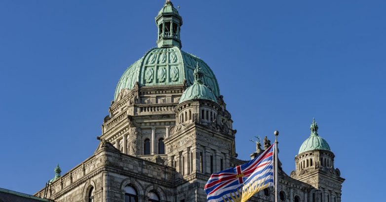 British Columbia Parliament building with flag and dome