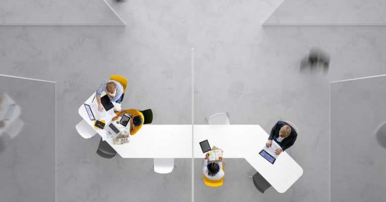 Overhead view of office team working on laptops