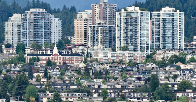 High-rise apartments above suburban neighborhood and trees