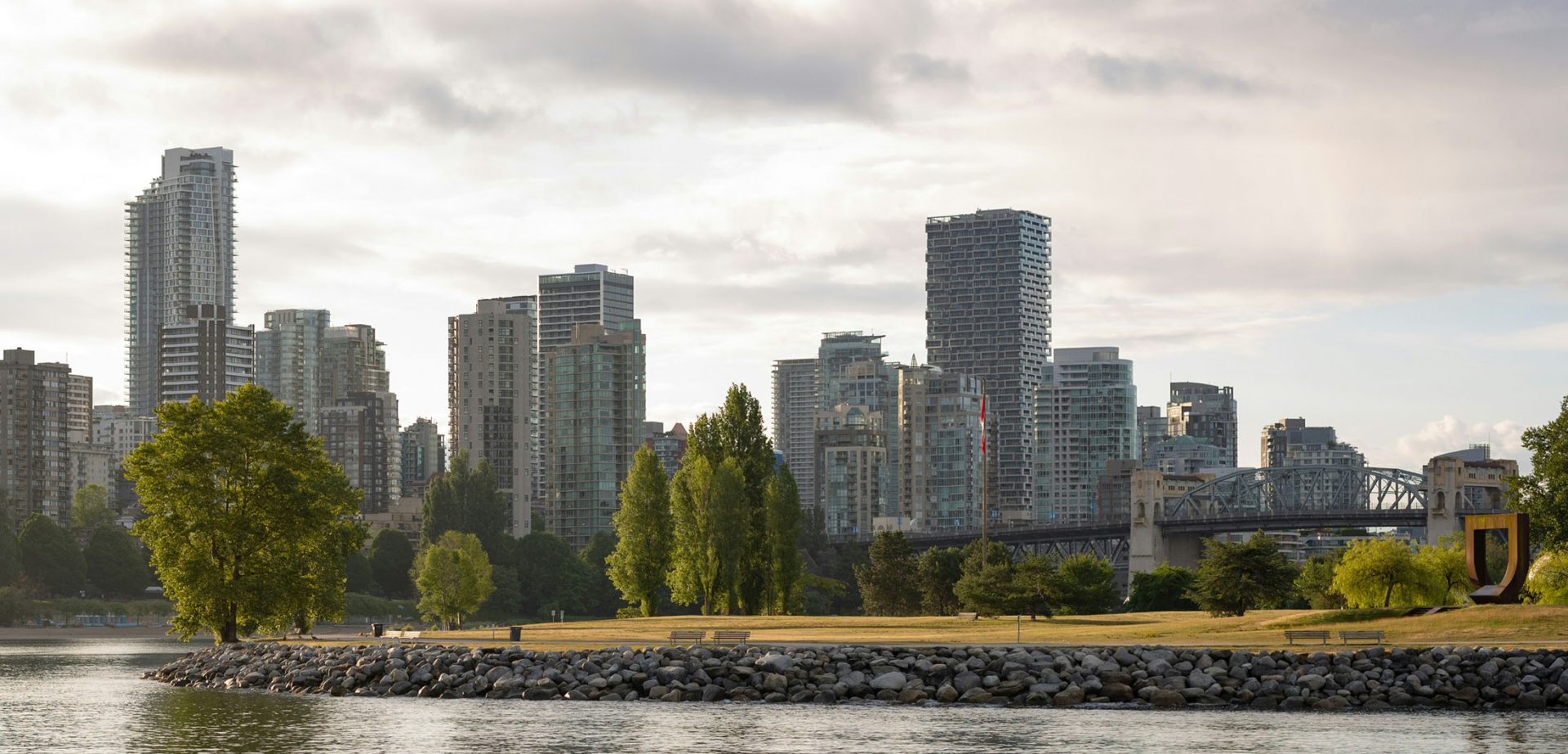 City skyline with waterfront park and bridge
