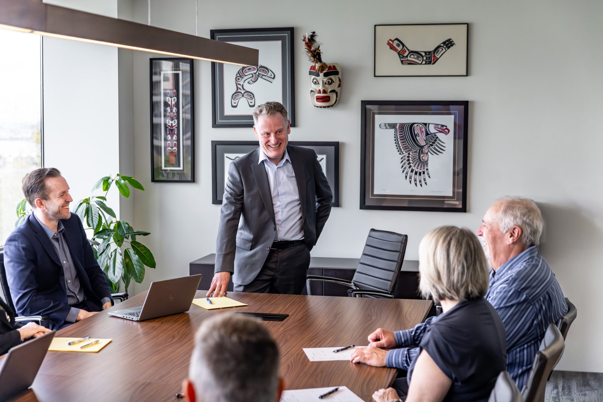 Business team meeting in modern glass office conference room