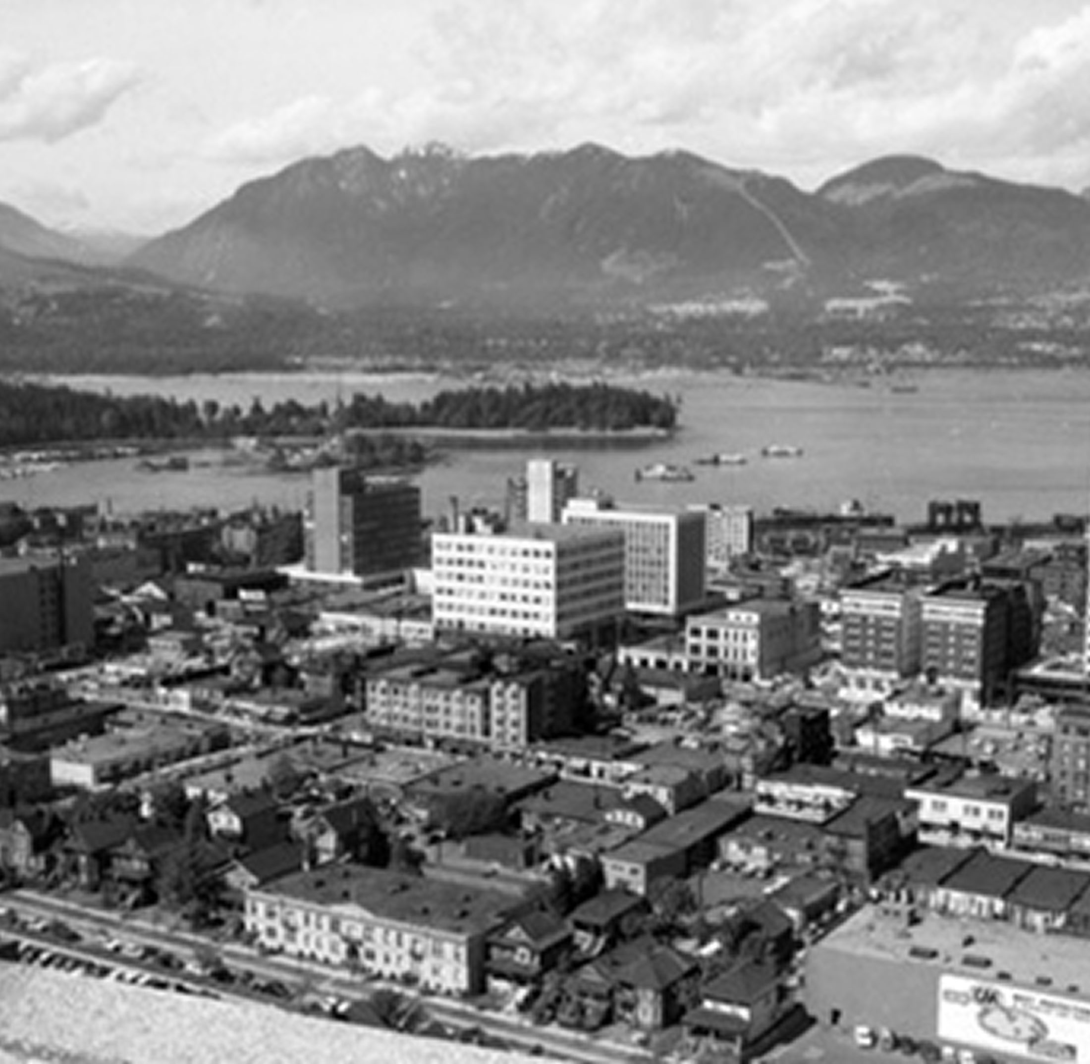Black-and-white cityscape with harbor and mountains