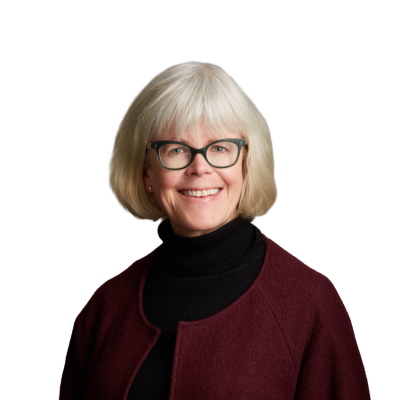 Smiling older woman with glasses and maroon jacket