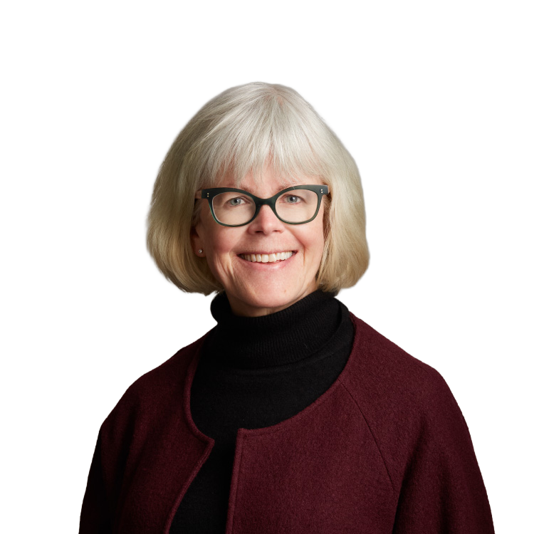 Smiling older woman with glasses and maroon jacket