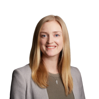 Professional headshot of smiling blonde woman in blazer