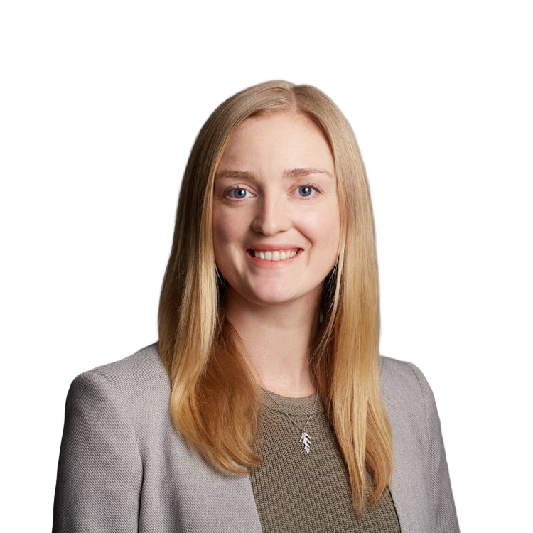 Professional headshot of smiling blonde woman in blazer