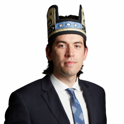 Man in suit wearing decorative ceremonial hat