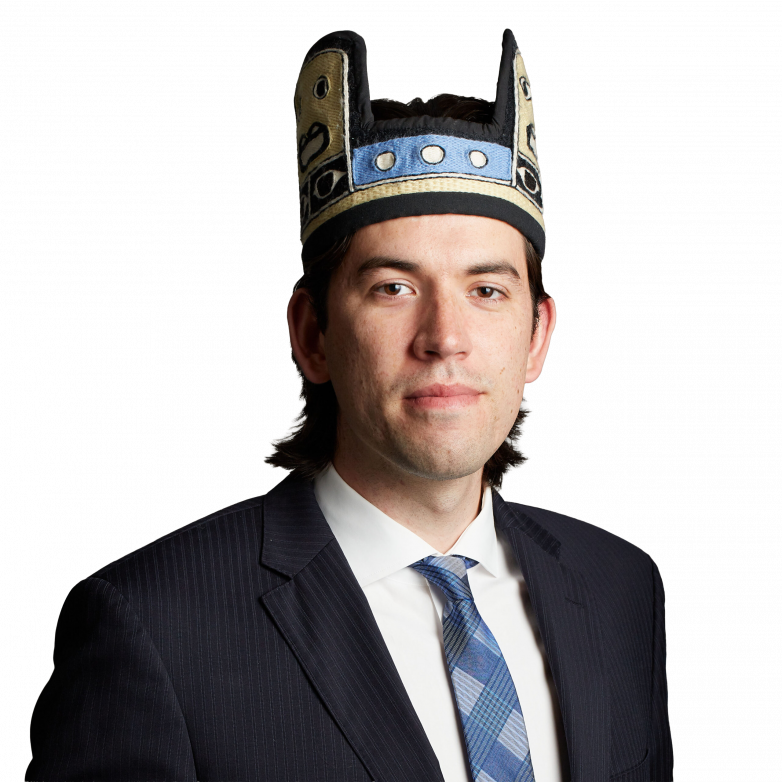 Man in suit wearing decorative ceremonial hat