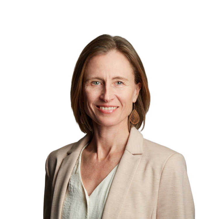 Professional headshot of smiling woman in beige blazer