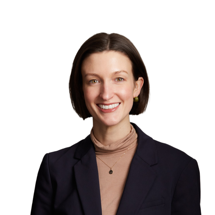 Professional headshot of smiling woman in navy blazer