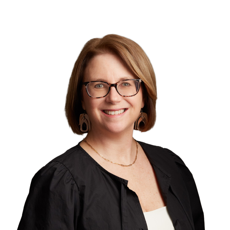 Smiling woman with glasses against neutral background