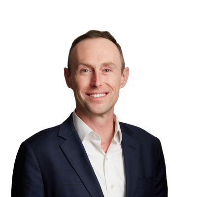Smiling man in navy suit against neutral background