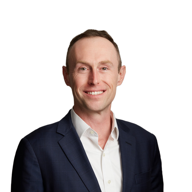 Smiling man in navy suit against neutral background
