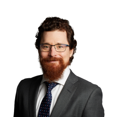 Man with red beard wearing suit and glasses