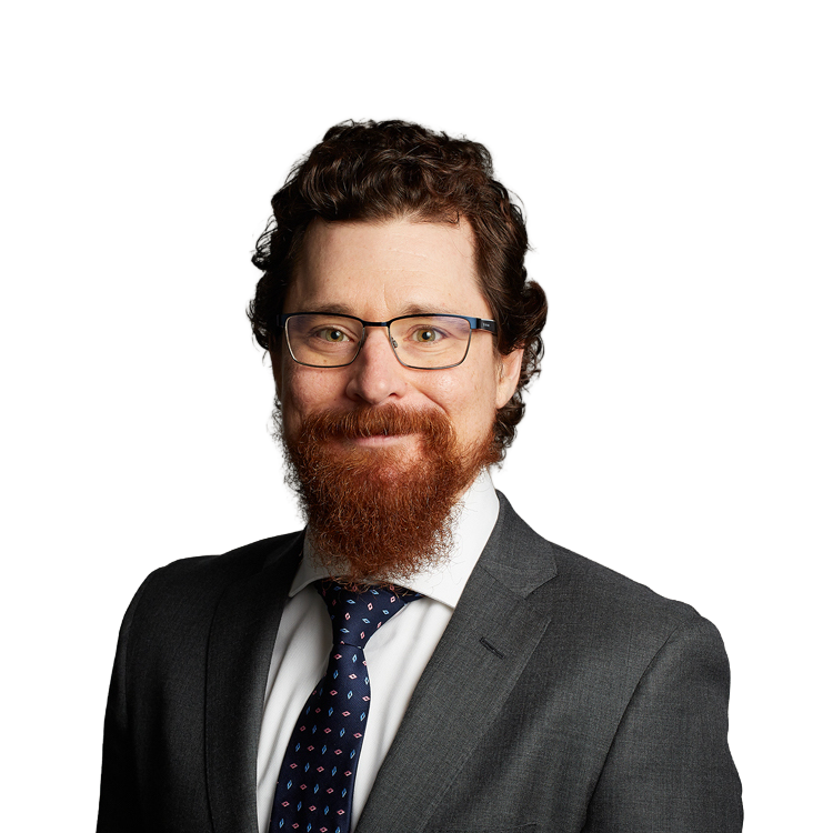 Man with red beard wearing suit and glasses