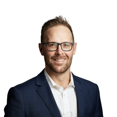 Smiling man in glasses wearing blue suit jacket