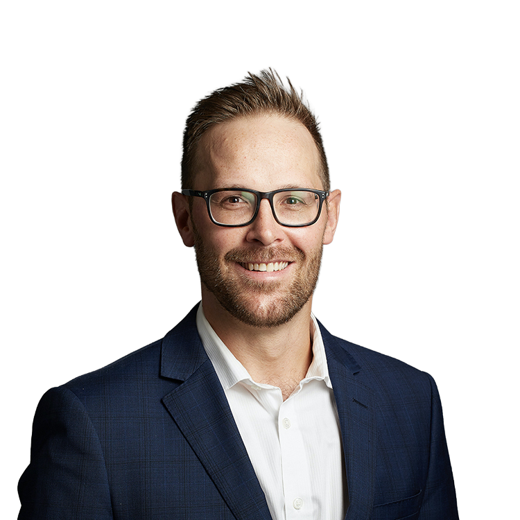 Smiling man in glasses wearing blue suit jacket