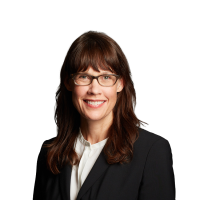 Smiling professional woman wearing glasses and blazer