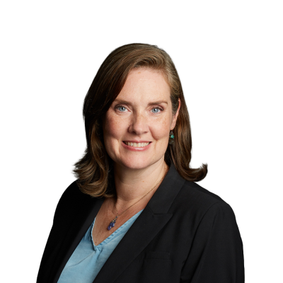 Professional headshot of woman in blazer smiling