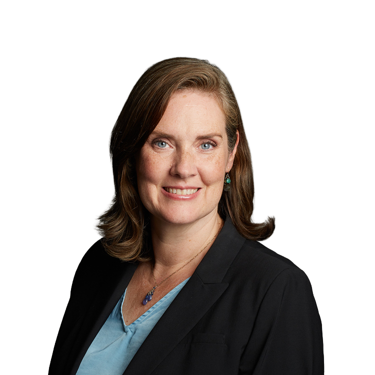 Professional headshot of woman in blazer smiling