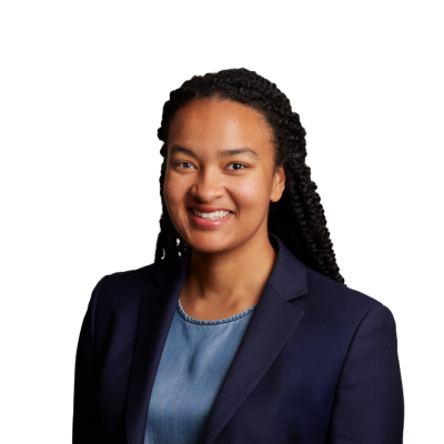 Professional headshot of smiling woman in navy blazer