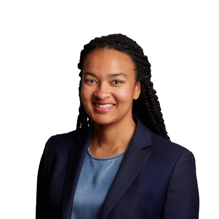 Professional headshot of smiling woman in navy blazer