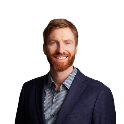 Smiling red-haired man in navy blazer portrait