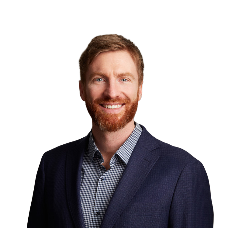 Smiling red-haired man in navy blazer portrait
